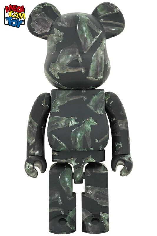 Large bear-shaped figure decorated with an Egyptian cat motif in dark tones with gold accents.