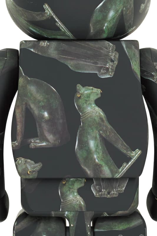 Large bear-shaped figure decorated with an Egyptian cat motif in dark tones with gold accents.
