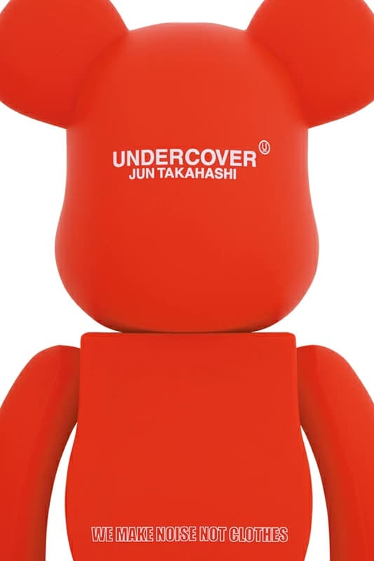Large red bear-shaped collectible figure with logo graphics across the chest.
