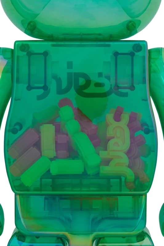 Standing bear-shaped collectible in translucent green plastic with printed logo lettering across the chest.