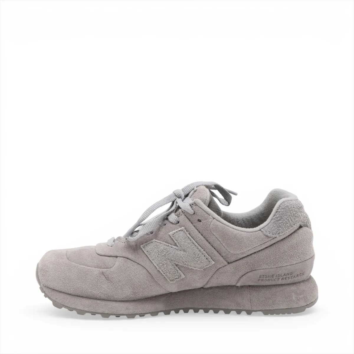 Pair of low-top grey suede sneakers in side view with mesh panelling and a white midsole.