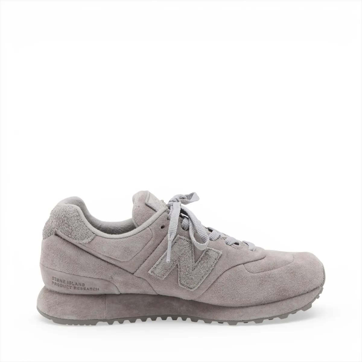 Pair of low-top grey suede sneakers in side view with mesh panelling and a white midsole.
