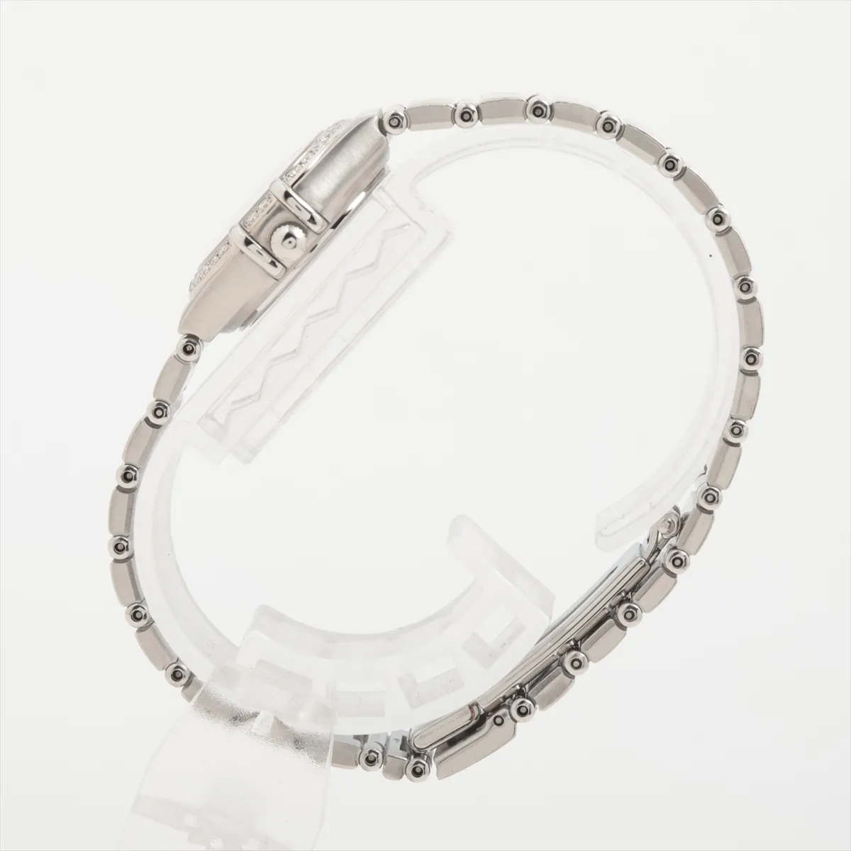 Steel bracelet watch with a pale shell-coloured dial and claw-style bezel detailing.