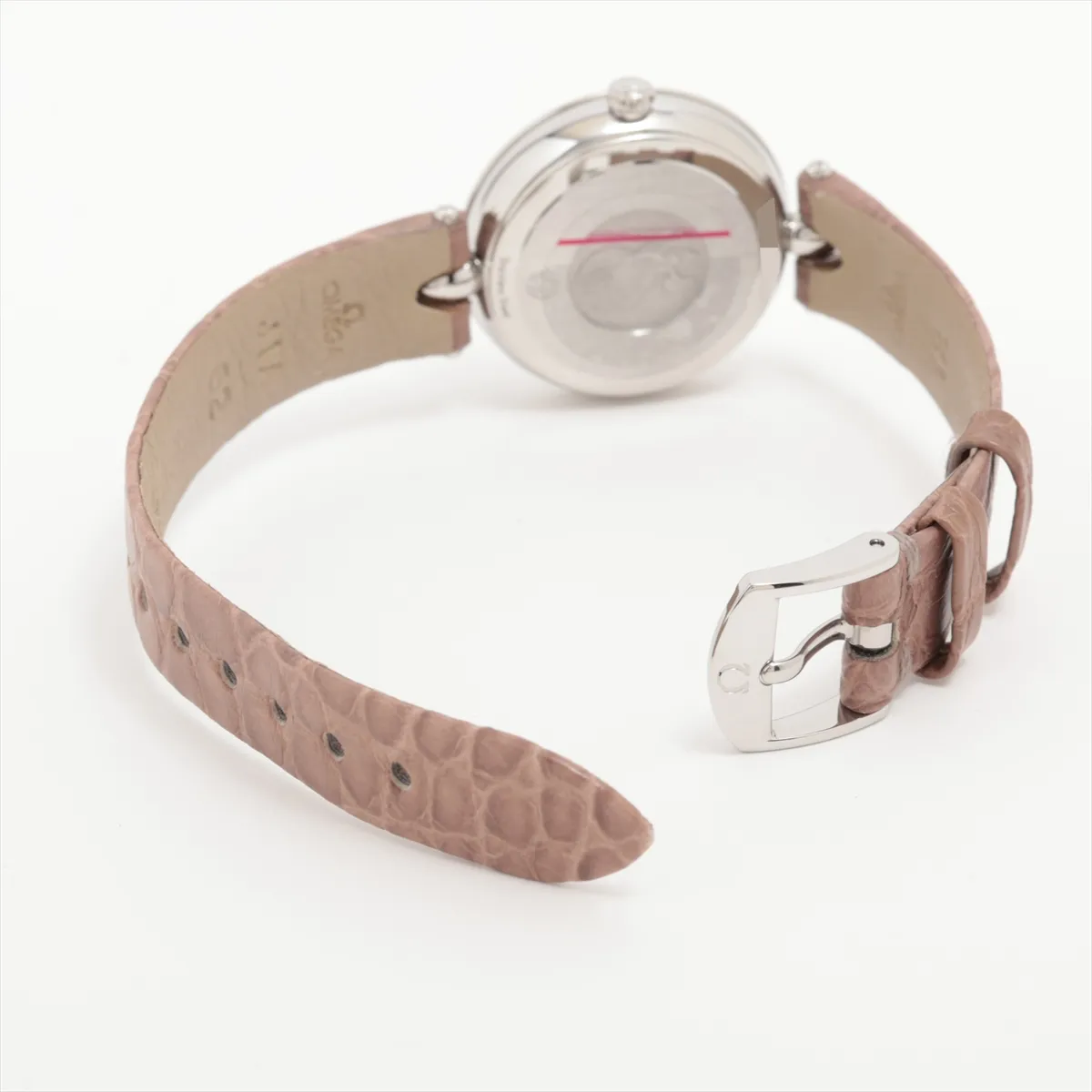 Small round watch with a pale dial and a dark leather strap.
