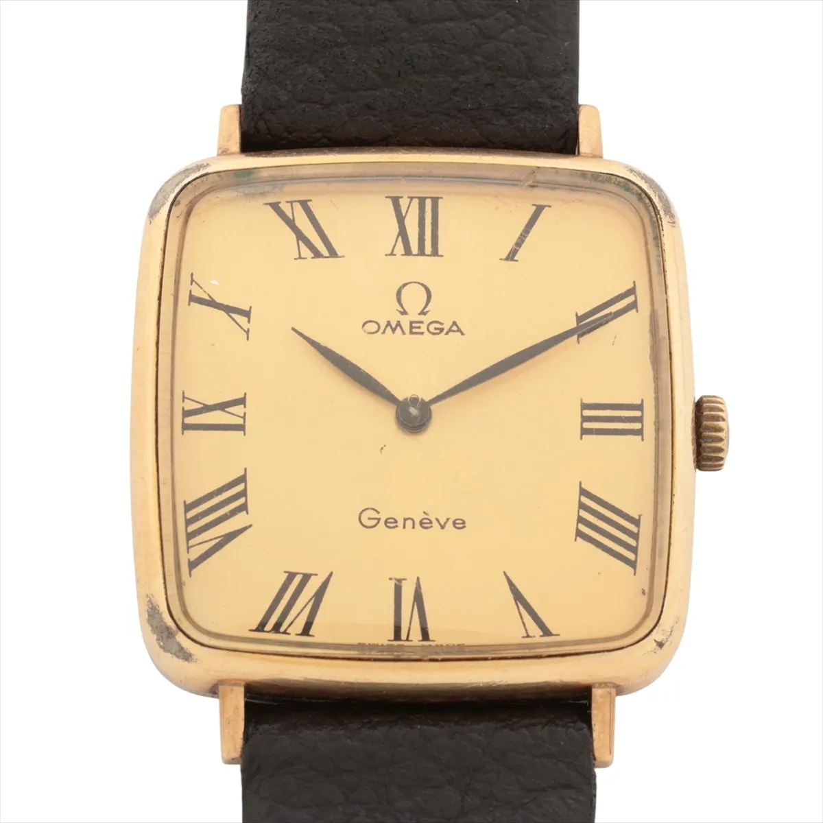 Small gold-tone watch with warm champagne dial and slim baton hands, fitted to a leather strap.