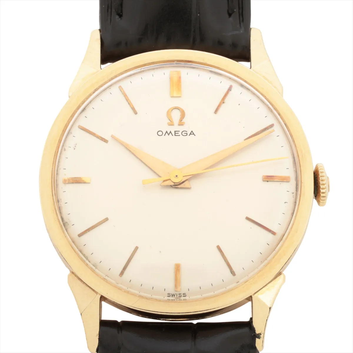 Gold-cased vintage watch with aged silver dial, slim hands and a leather strap.