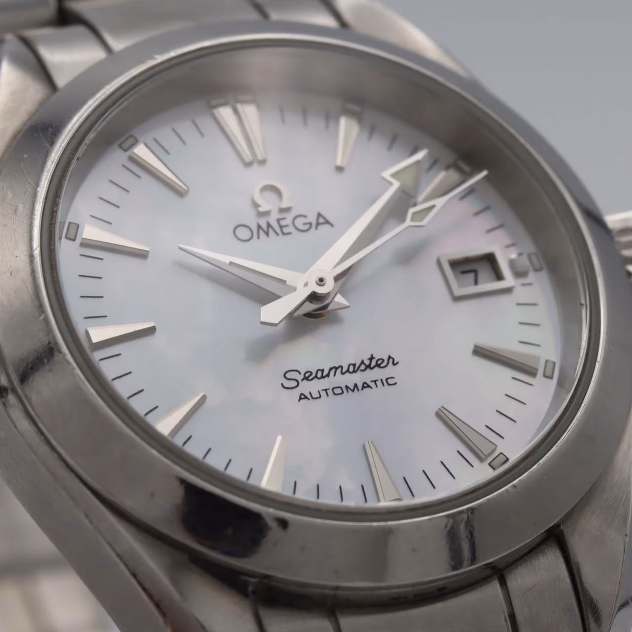 Stainless steel wristwatch with a bracelet and round dial, shown face on.