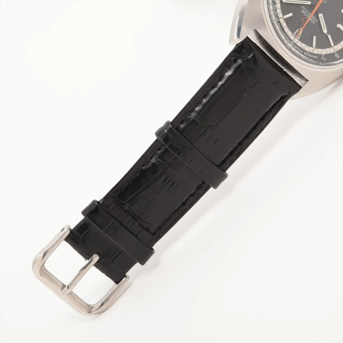 Vintage round steel chronograph with a black dial and dark leather strap.