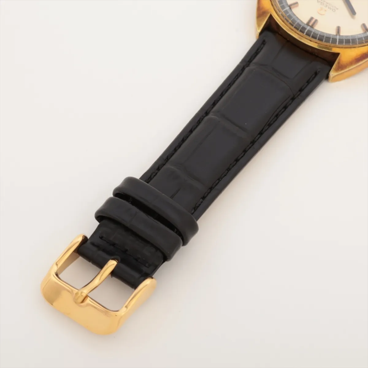 Vintage champagne-dial automatic watch in a gold-tone case on a strap, dial facing the camera