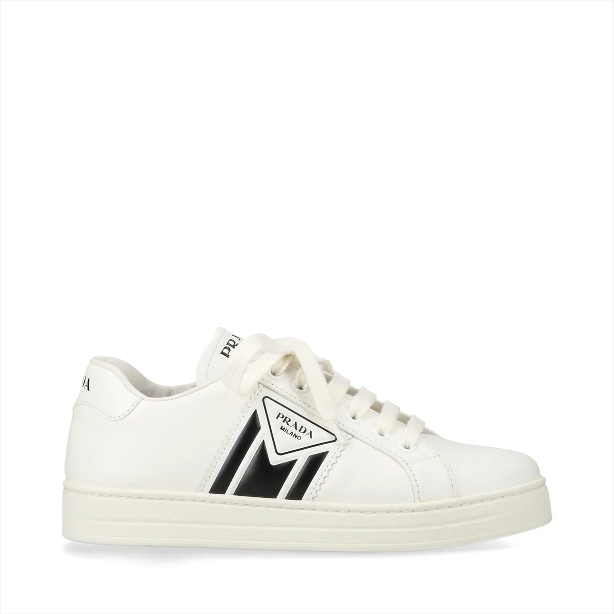 Pair of low-top white leather shoes with black trim, photographed against a plain background.