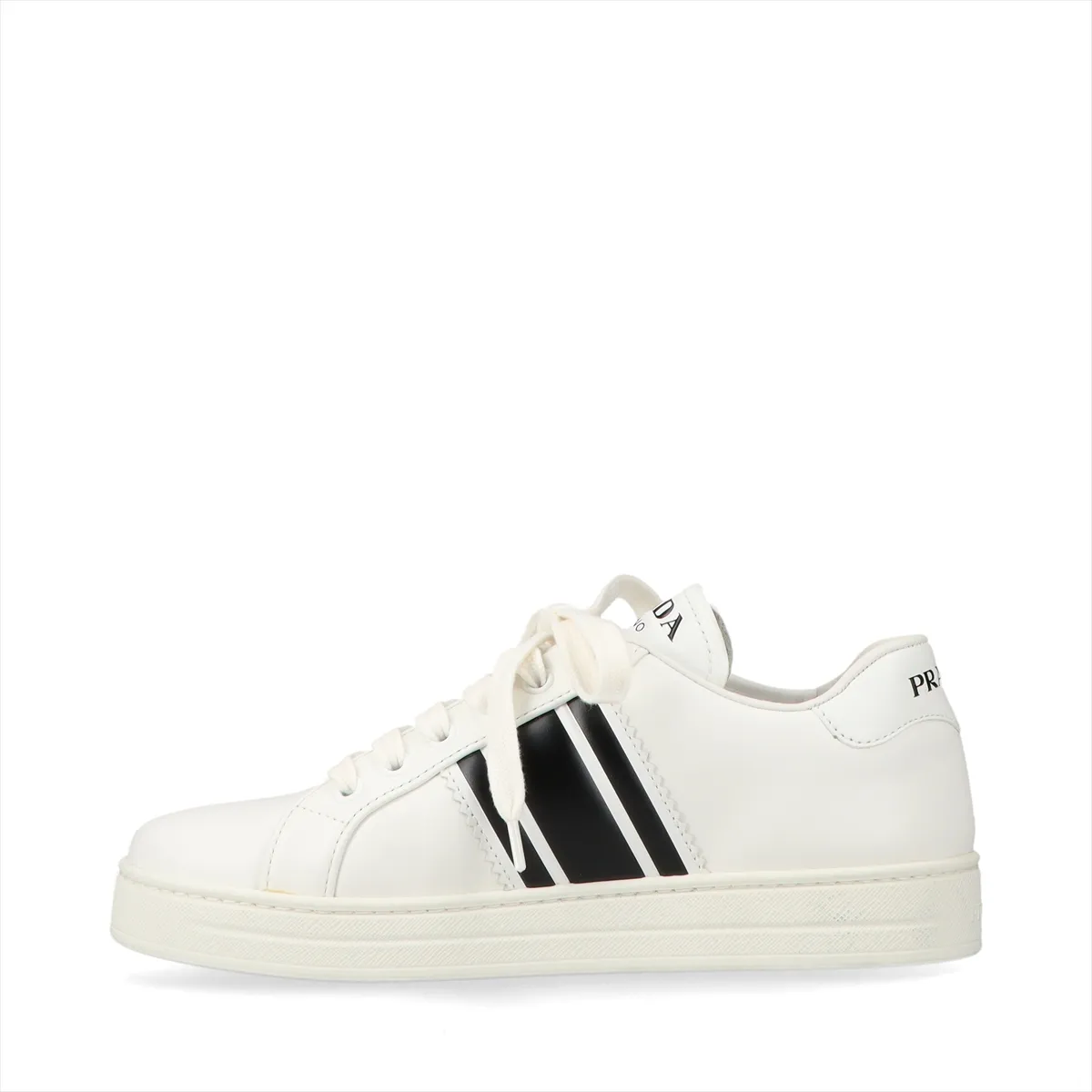 Pair of low-top white leather shoes with black trim, photographed against a plain background.