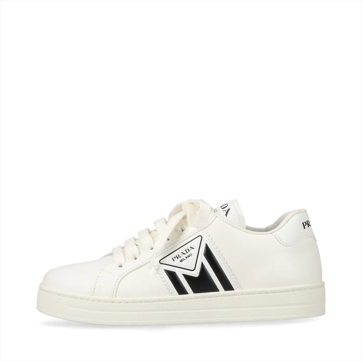 Pair of low-top white leather shoes with black trim, photographed against a plain background.