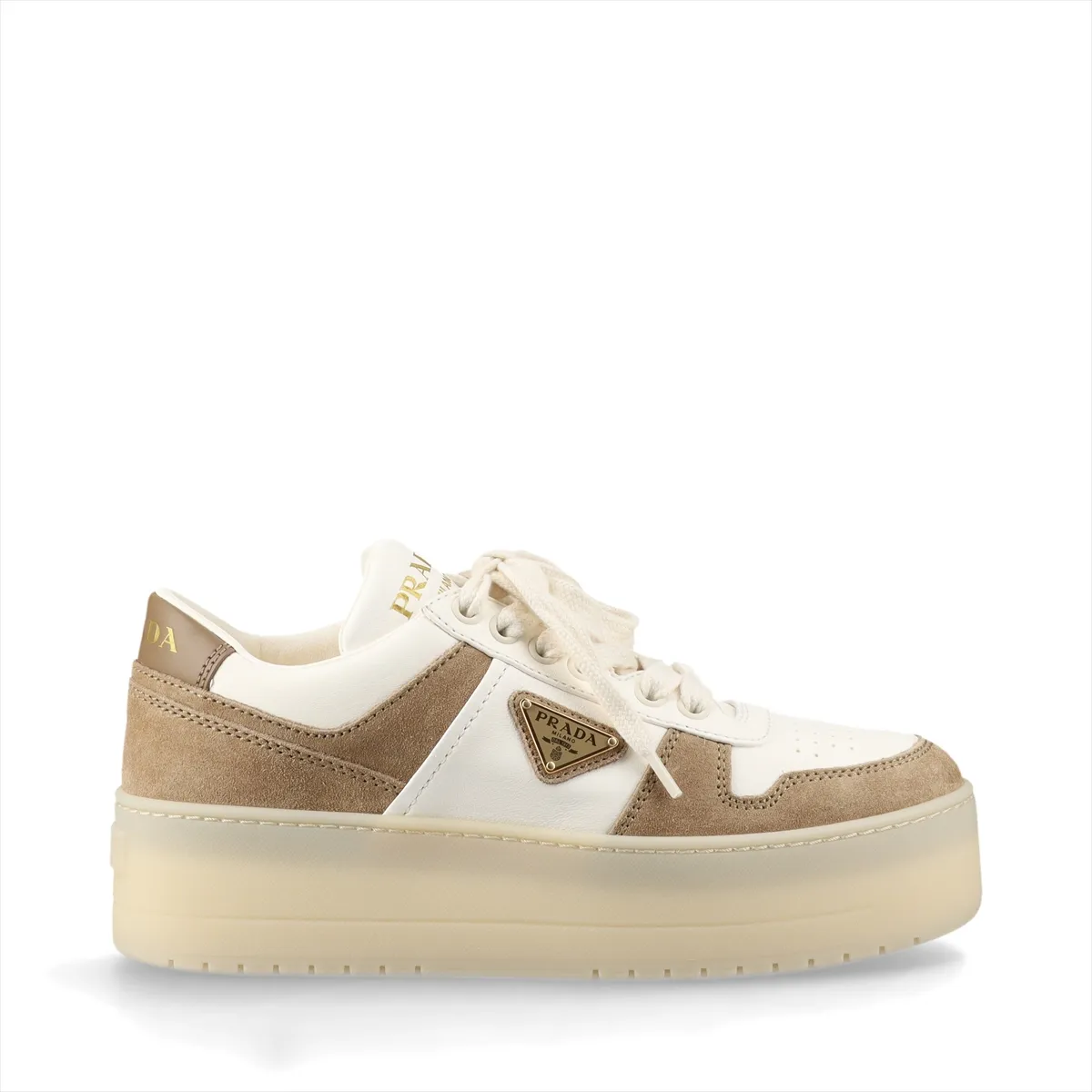 Thick-soled platform shoe in white and brown with a triangular metal logo plaque on the side.