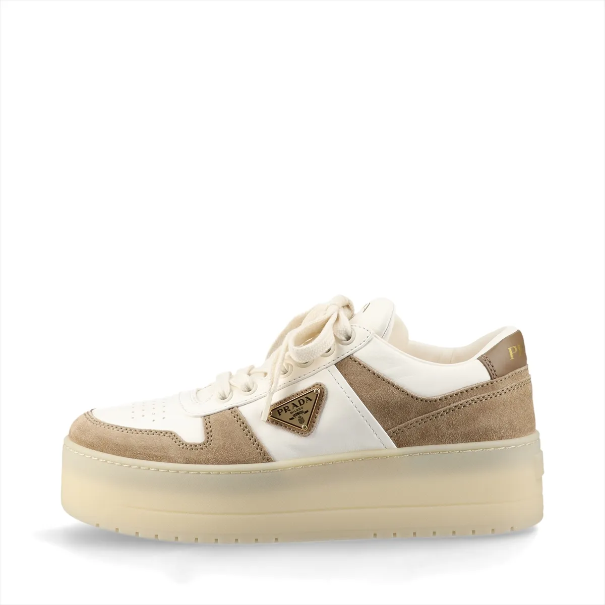 Thick-soled platform shoe in white and brown with a triangular metal logo plaque on the side.