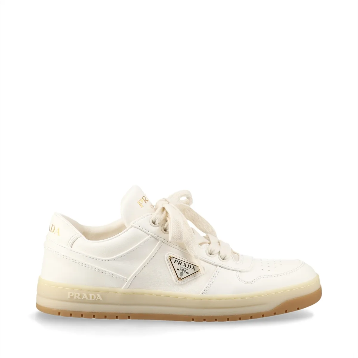 Ivory leather low-top sneakers with a small triangular metal plaque on the side and white soles.