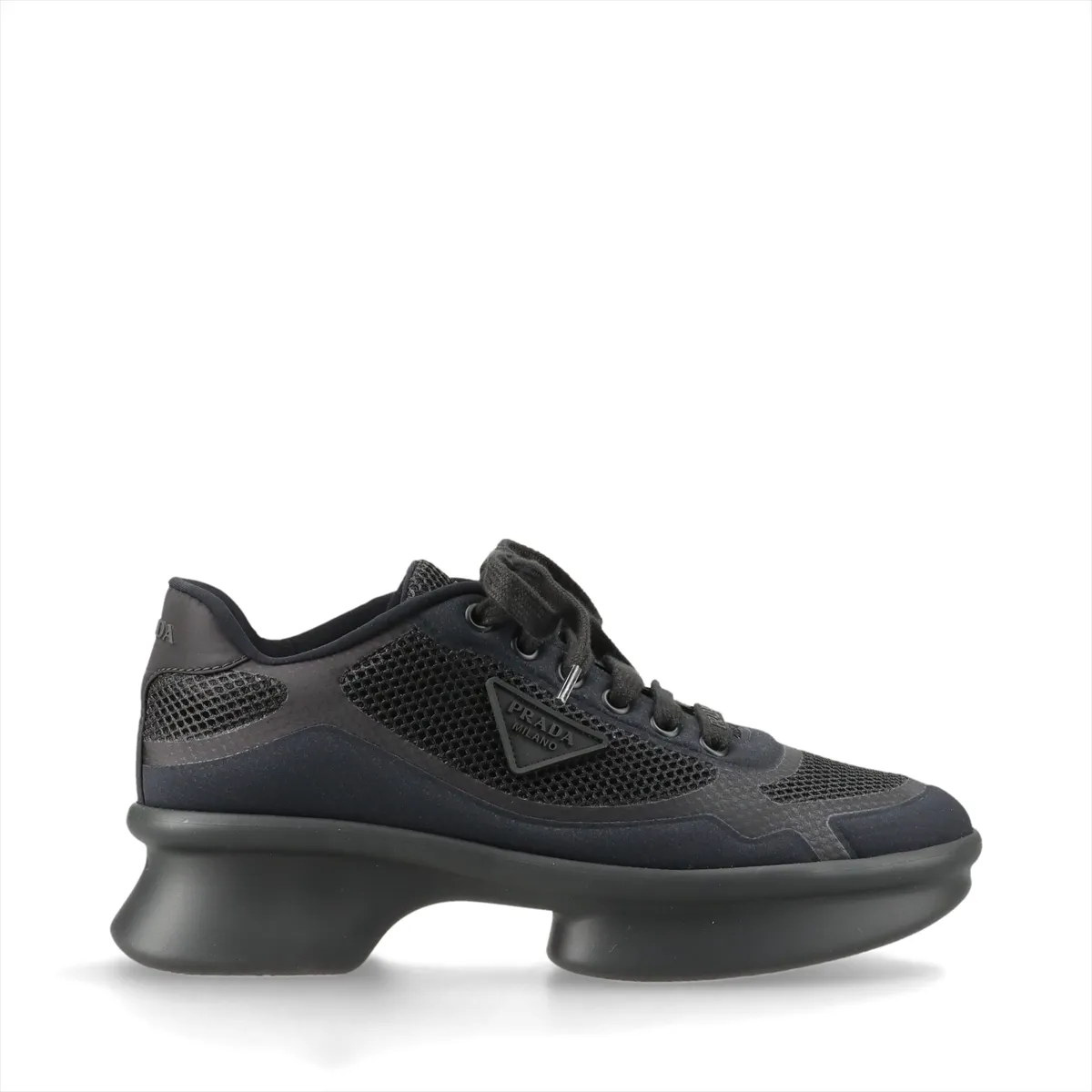 Dark navy platform sneaker with black trim, mesh panel and small triangle metal plaque.