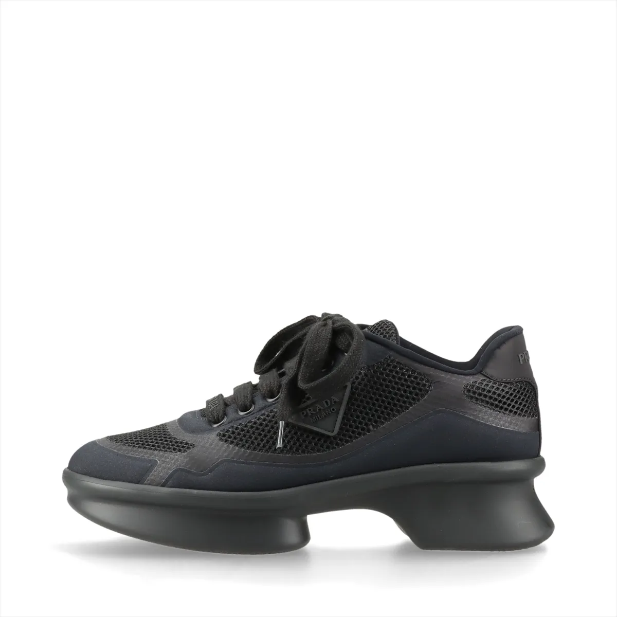 Dark navy platform sneaker with black trim, mesh panel and small triangle metal plaque.