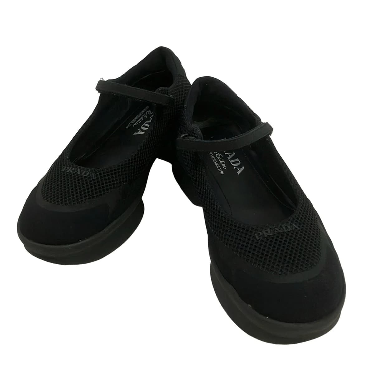 Black mesh low-top footwear, side view