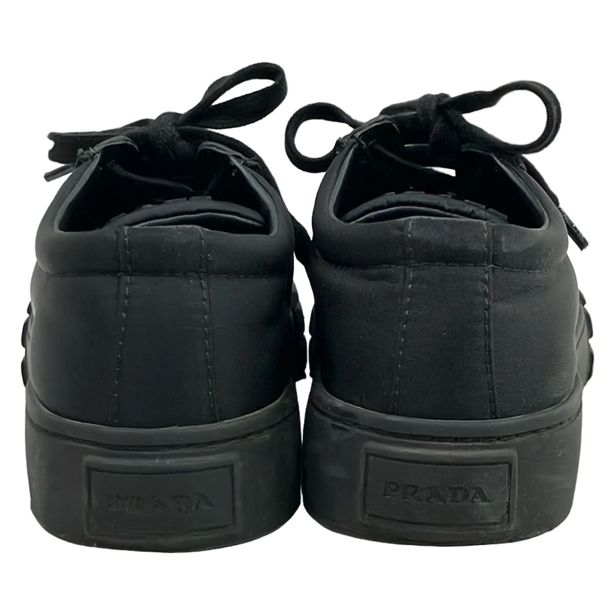 Black low-top lace-up footwear, side view