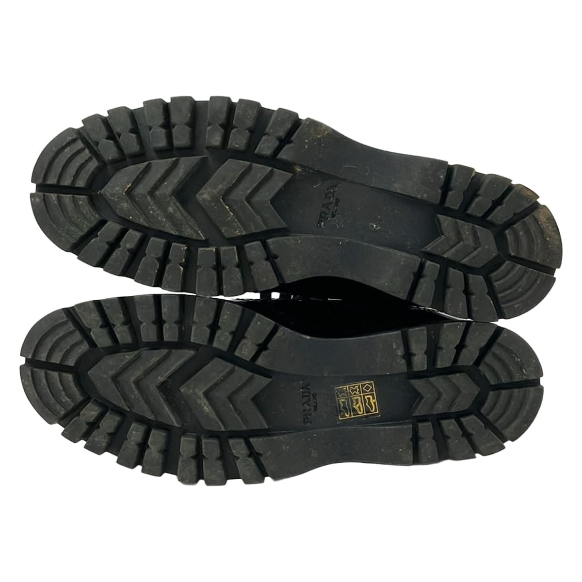 Pair of black leather low-top shoes with laces, shown side on.