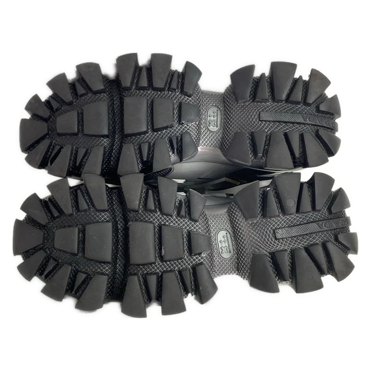 Black footwear with silver trim on a chunky raised sole