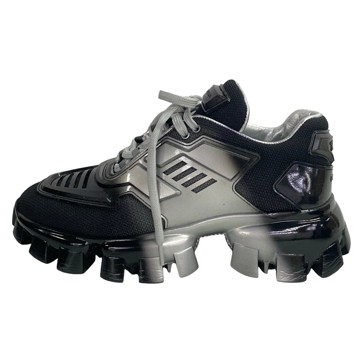 Black footwear with silver trim on a chunky raised sole