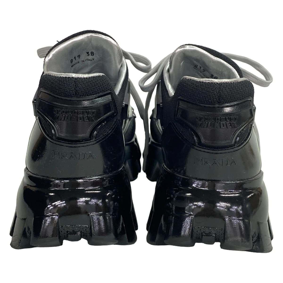 Black footwear with silver trim on a chunky raised sole