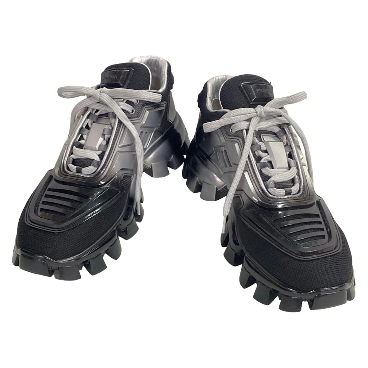 Black footwear with silver trim on a chunky raised sole