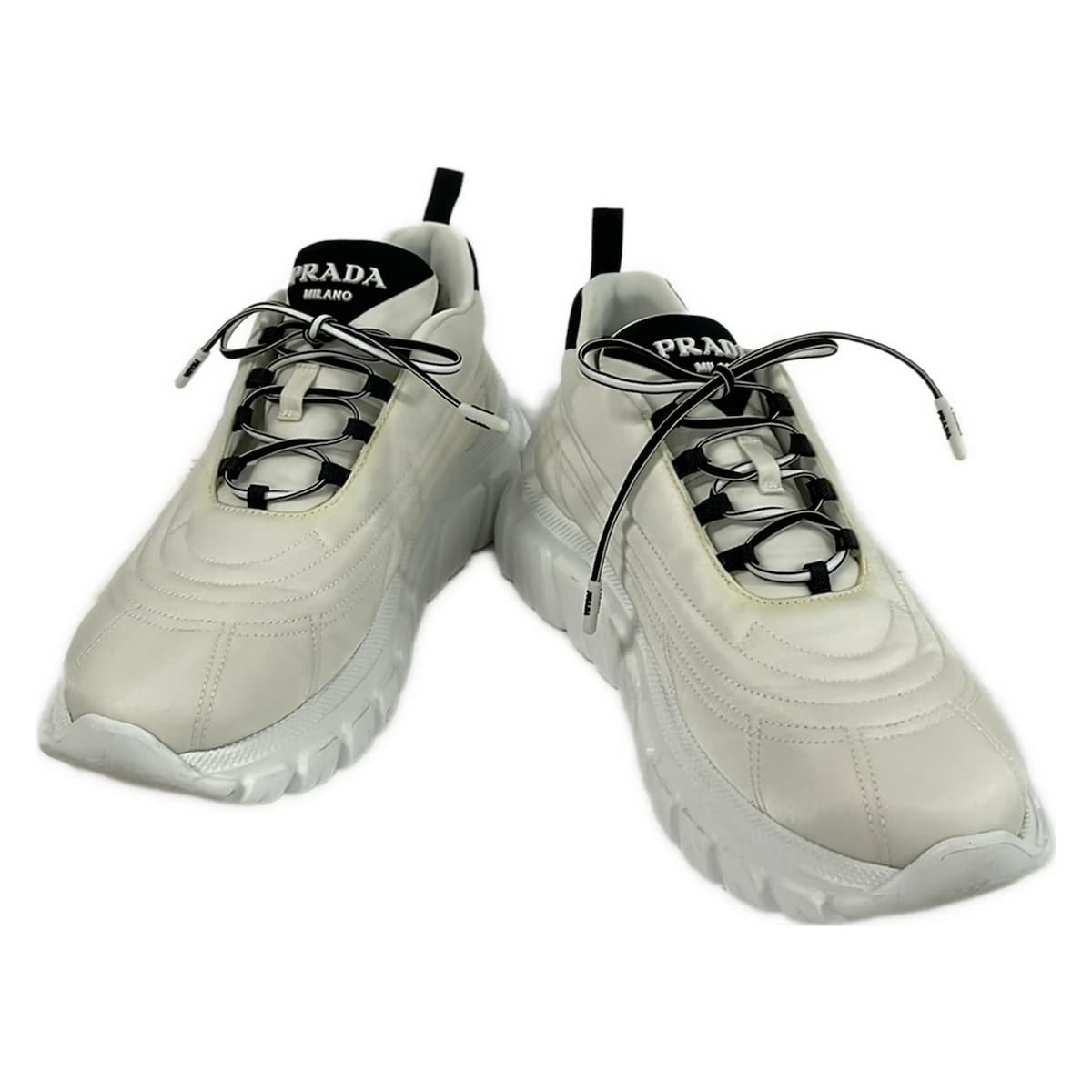 White and black low-top lace-up footwear, side view