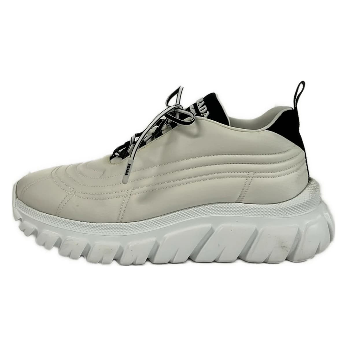 White and black low-top lace-up footwear, side view