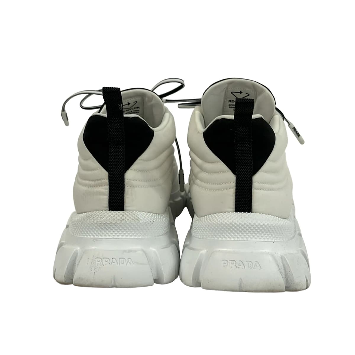 White and black low-top lace-up footwear, side view