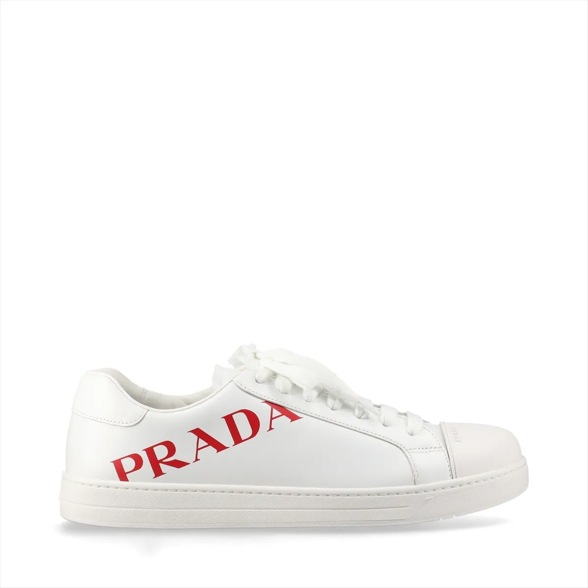 White low-top sneakers with red trim and a logo on the side panel.