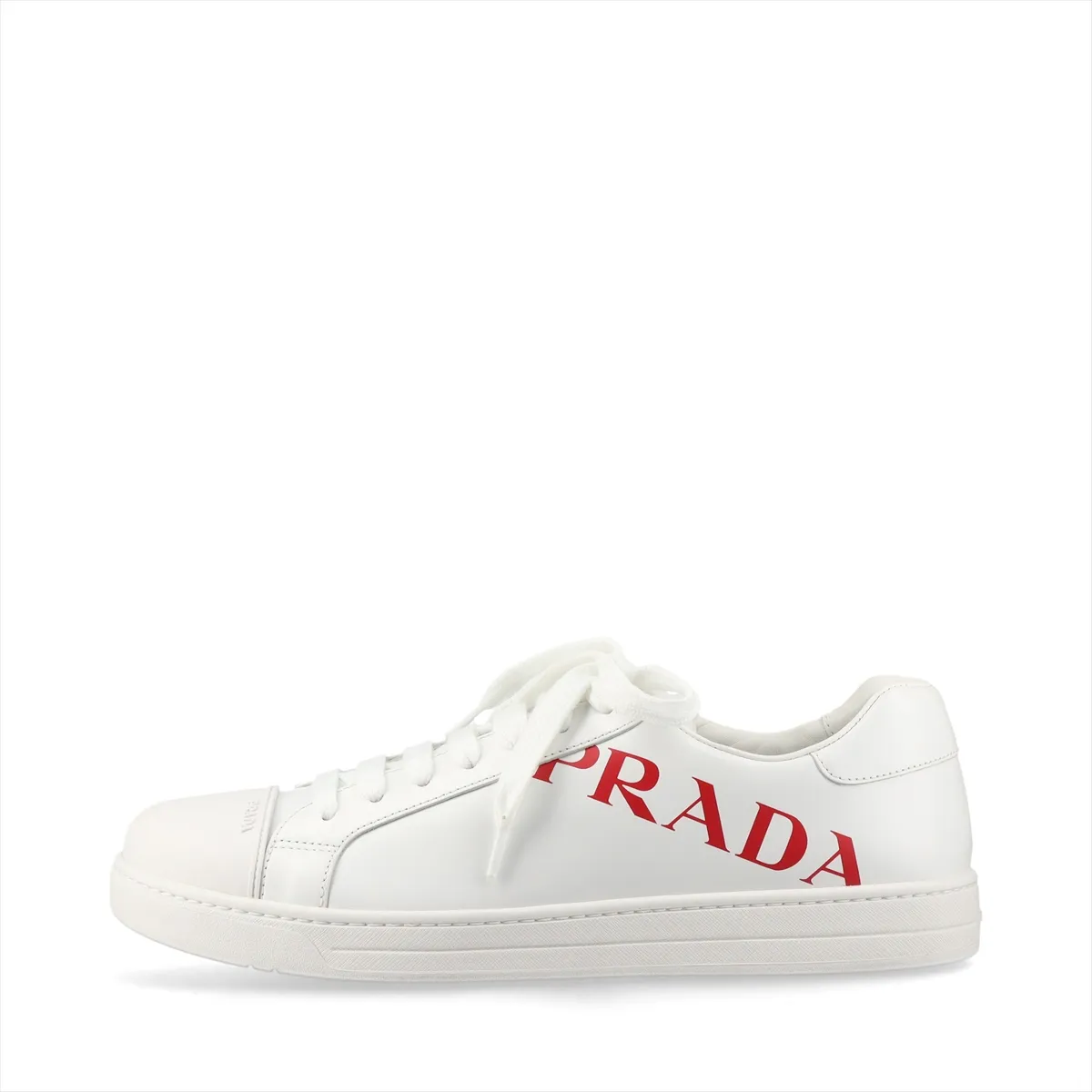 White low-top sneakers with red trim and a logo on the side panel.