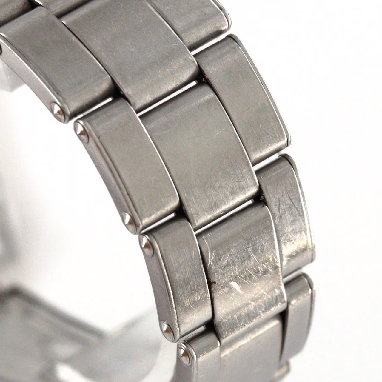 Steel manual-wind wristwatch with date window at three o'clock and steel bracelet.