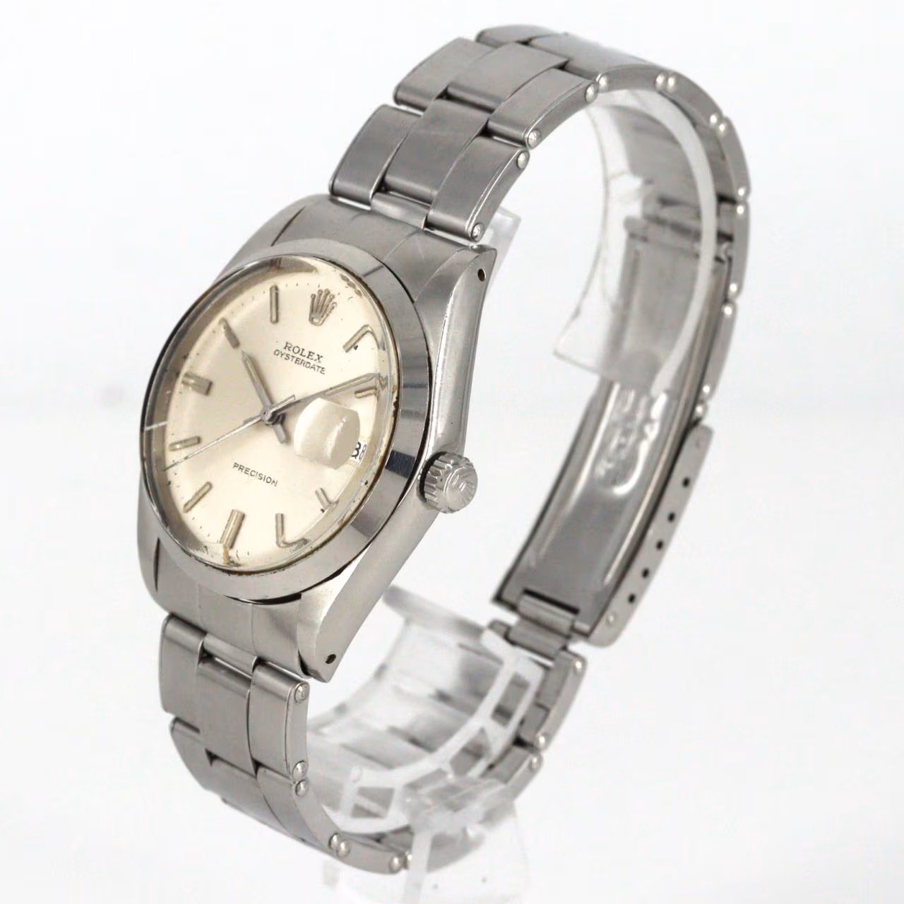 Steel manual-wind wristwatch with date window at three o'clock and steel bracelet.