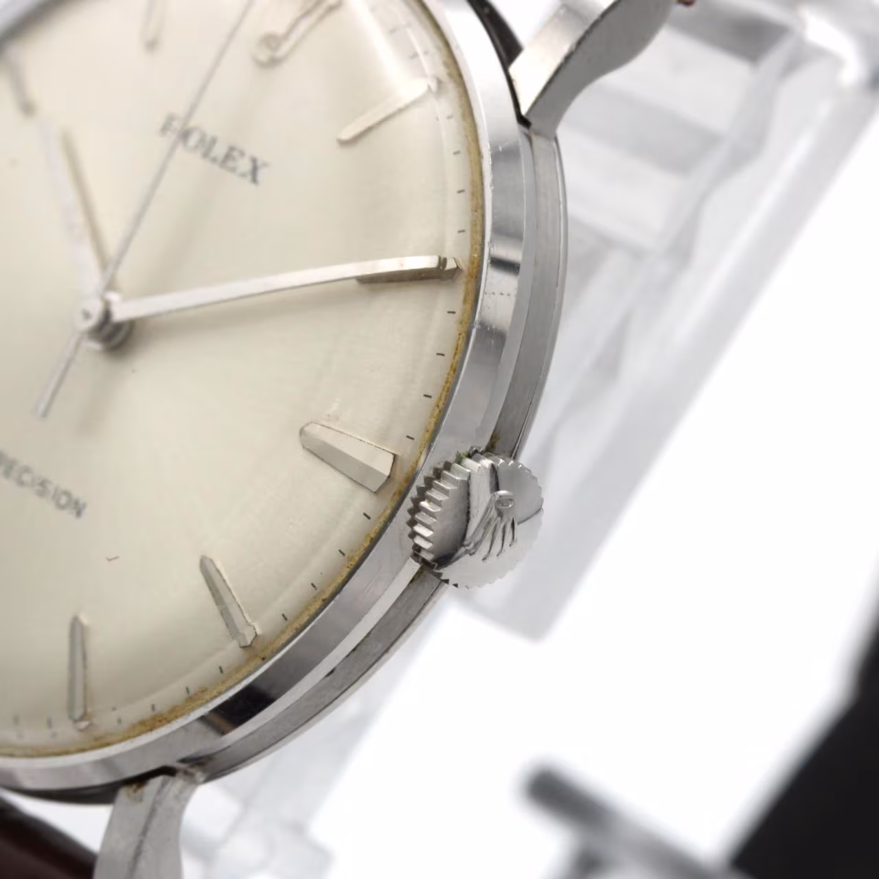 Stainless steel wristwatch with a plain dial and slim baton hands.