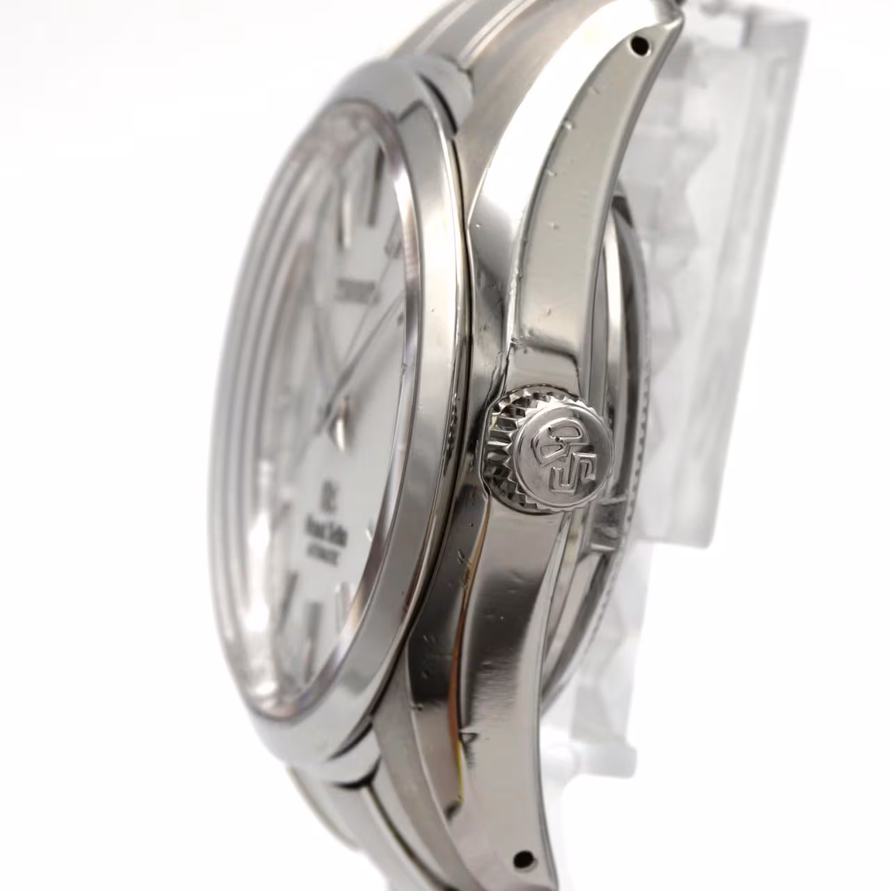 Stainless steel wristwatch with a light dial, baton hands and a matching bracelet.