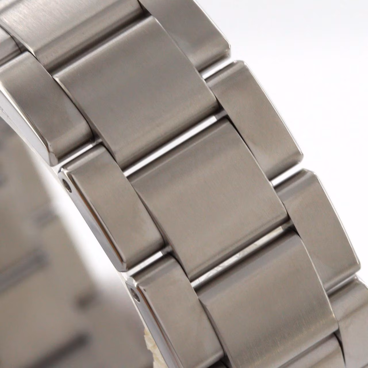 Stainless steel wristwatch with a plain dial, baton markers and a steel bracelet.