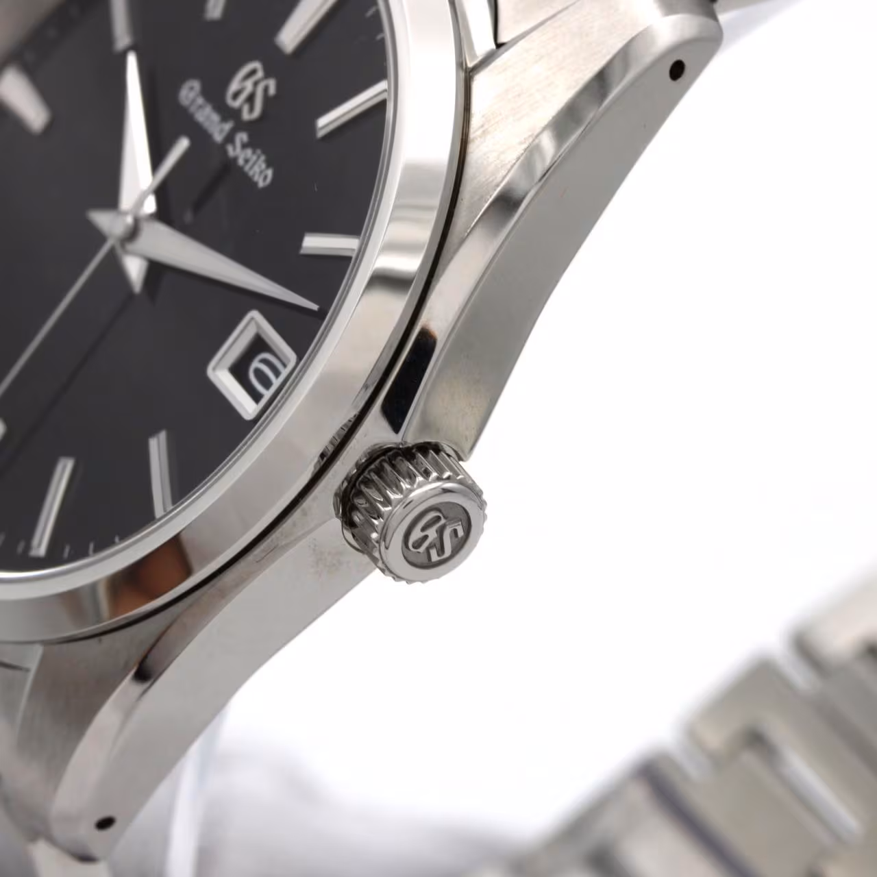 Stainless steel wristwatch with a light dial, baton markers and a matching steel bracelet.