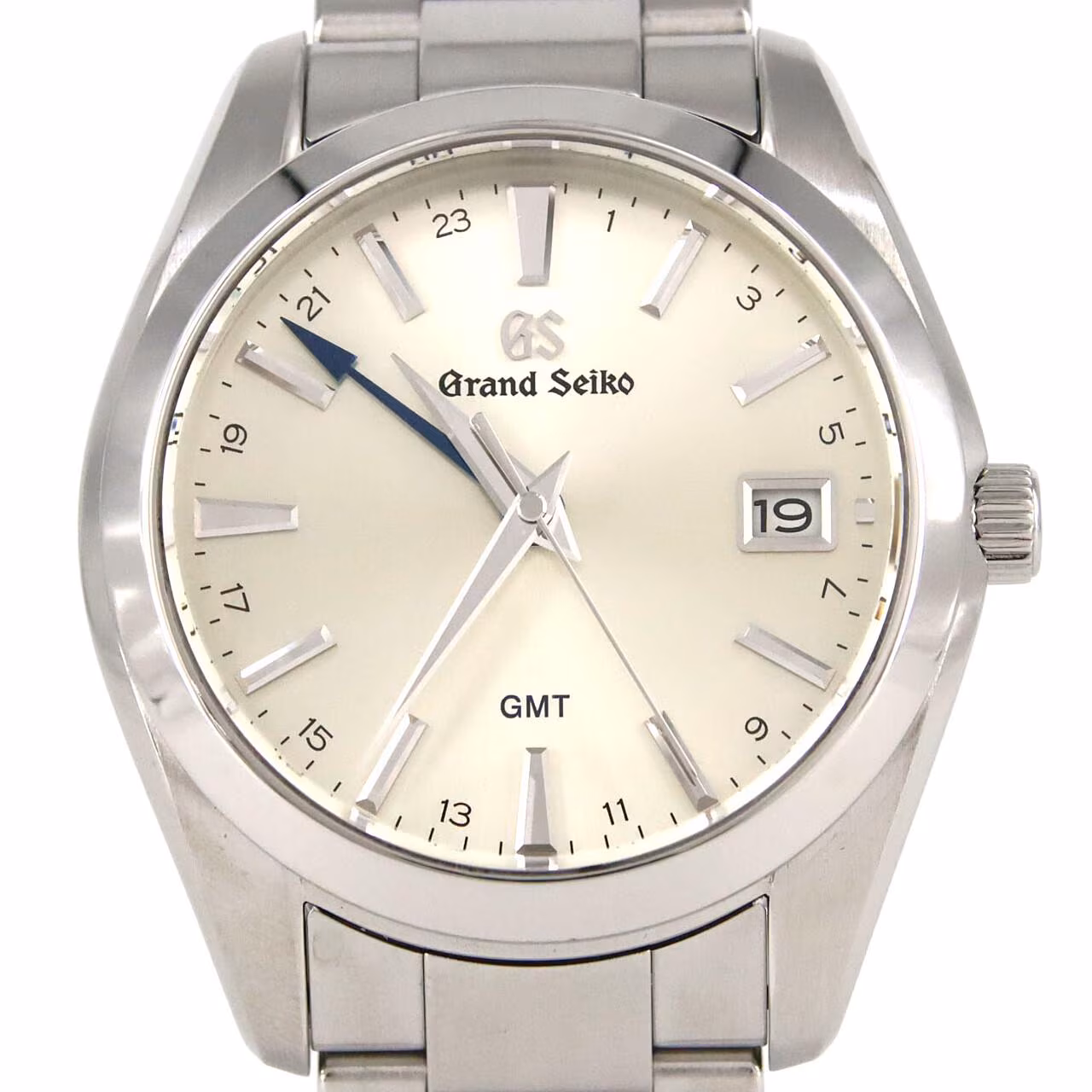 Stainless steel wristwatch with silver dial, blue-tipped GMT hand, date window and steel bracelet.