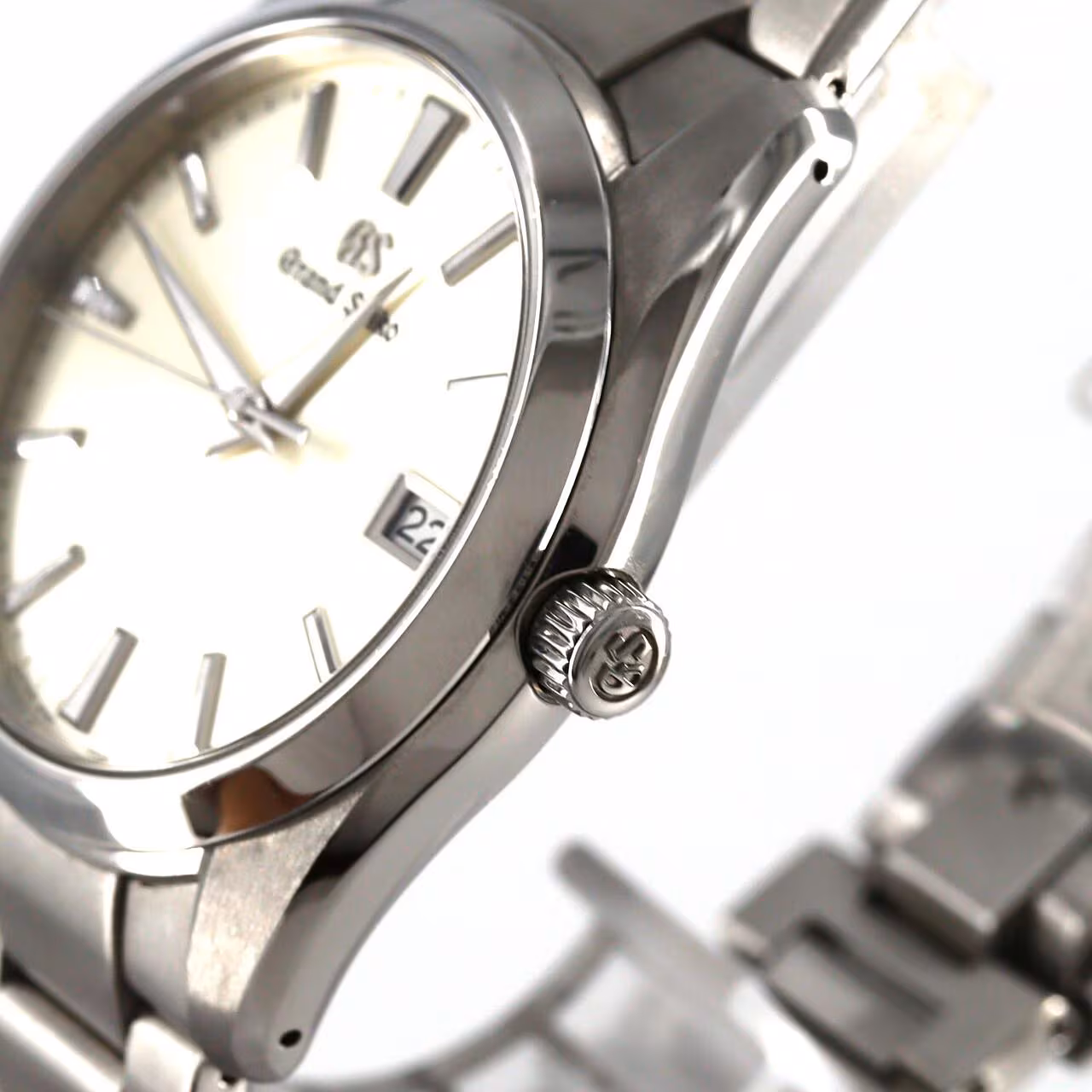 Stainless steel wristwatch with a bright dial and brushed steel bracelet.