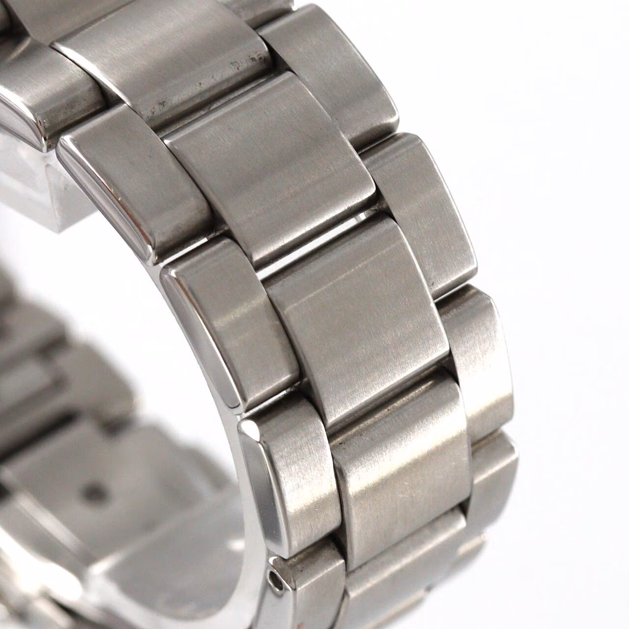 Stainless steel wristwatch with a bright dial and brushed steel bracelet.