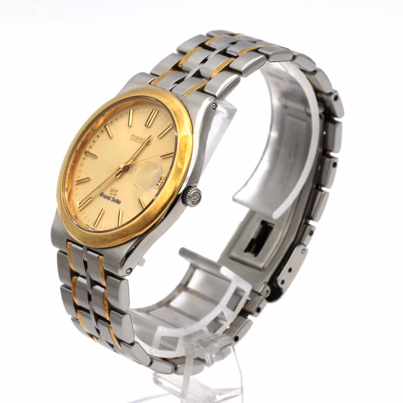 Two-tone wristwatch with steel and gold bracelet links, pale dial, baton markers and date window.