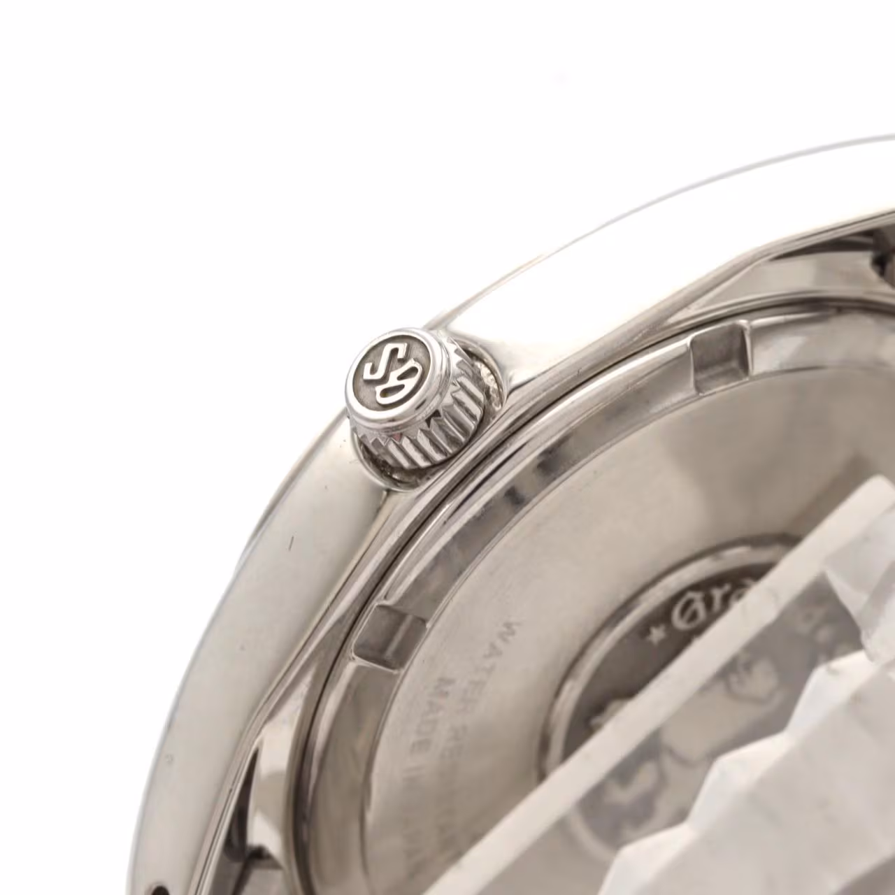 Steel wristwatch with pale dial, date window and polished steel bracelet.