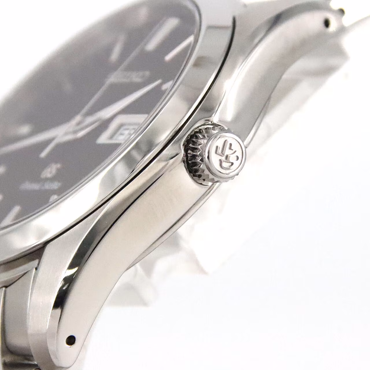 Round polished steel watch on a matching steel bracelet with a light dial and date window.