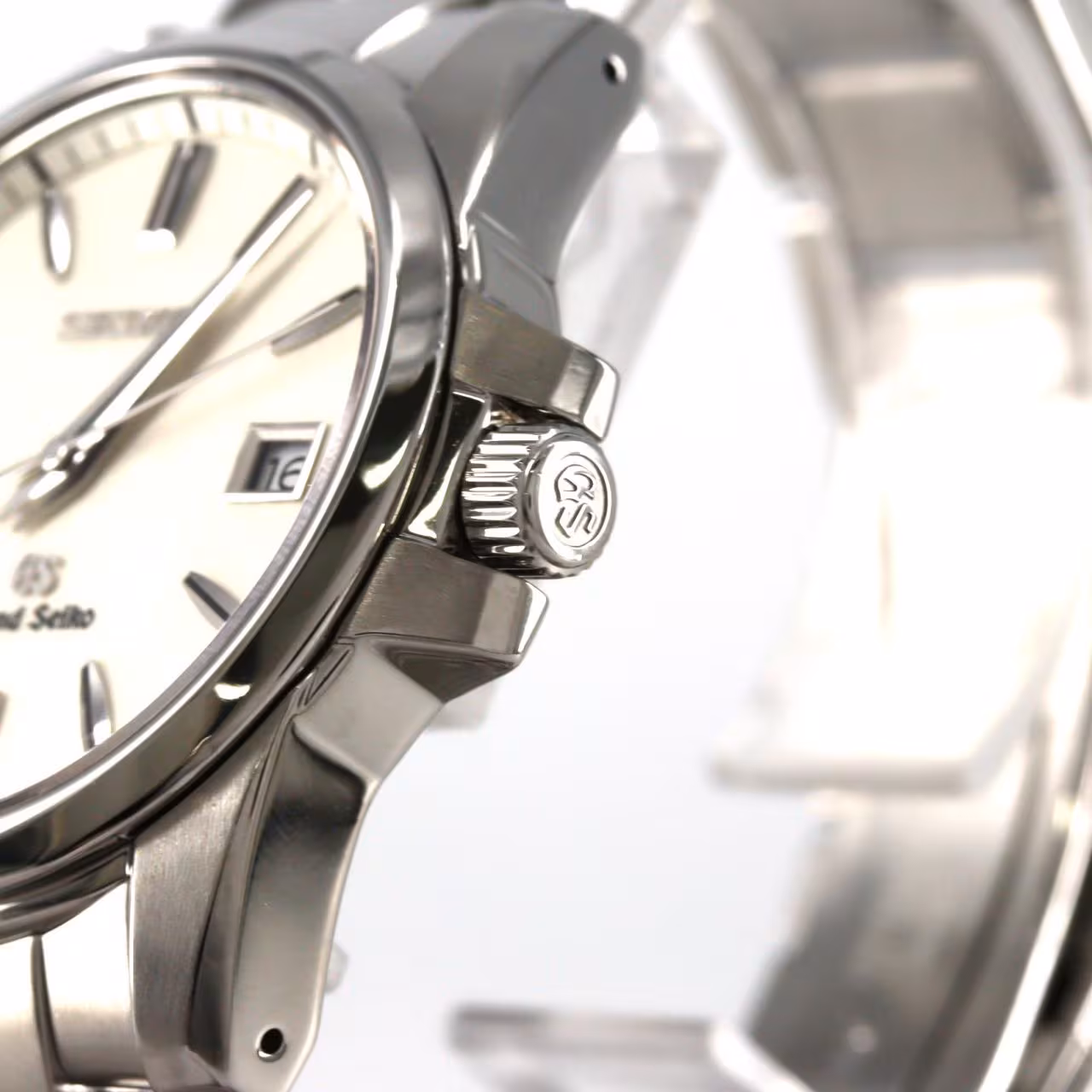 Stainless steel wristwatch with polished case, simple dial and steel bracelet.