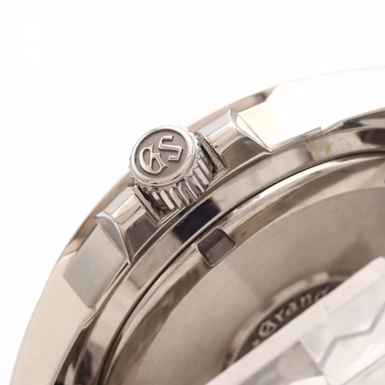 Titanium wristwatch with a light dial, power reserve indicator, date window and brushed bracelet.