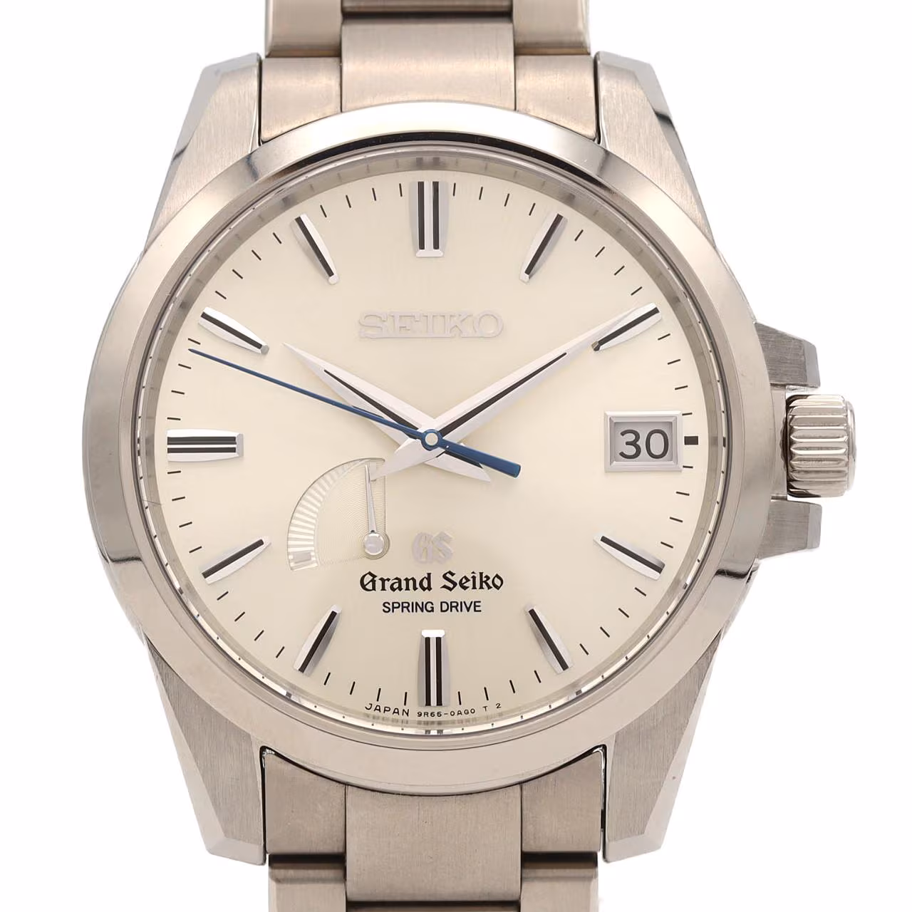 Titanium wristwatch with a light dial, power reserve indicator, date window and brushed bracelet.
