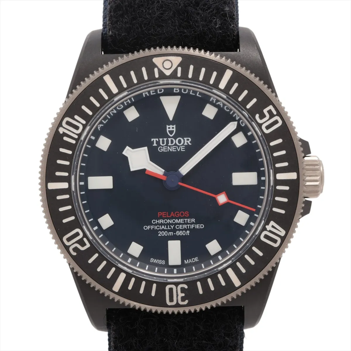 Diver's watch with a dark carbon case, blue dial and matching fabric strap.