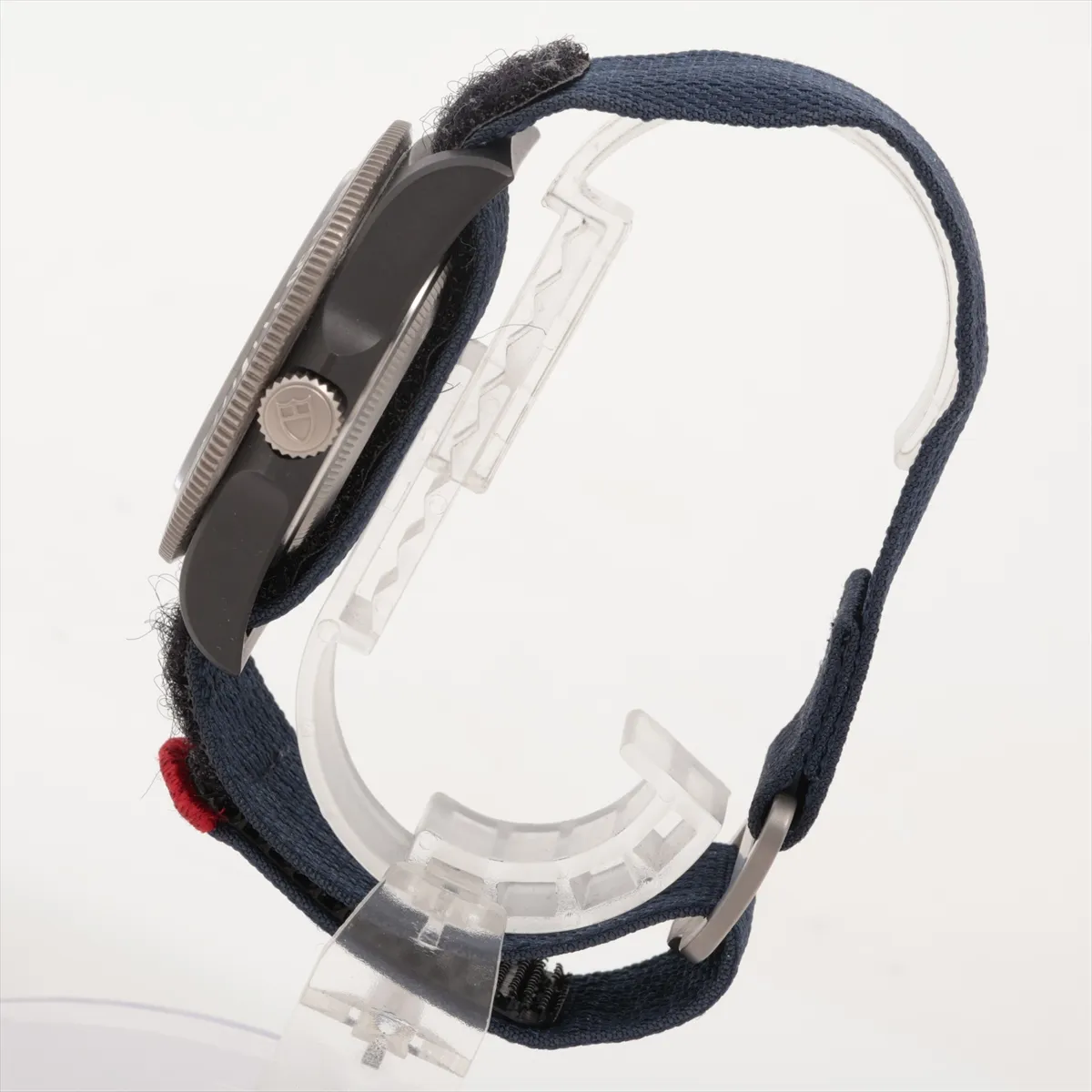 Diver's watch with a dark carbon case, blue dial and matching fabric strap.